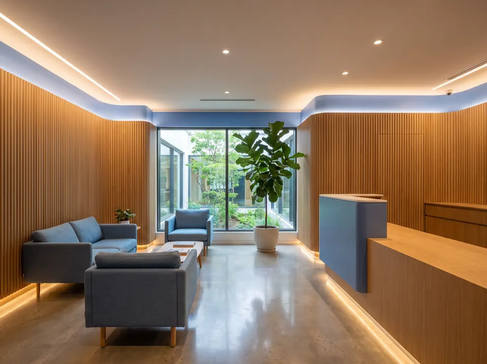 Calm modern dental clinic lobby with warm wood and soft blue lighting